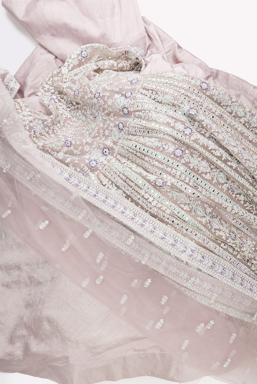 Flat lay of Lilac Banarasi Silk Womens Lehenga set featuring Embroidered Choli paired with Lilac Embroidered Skirt with Embroidered Border and a Embroidered dupatta in Lilac