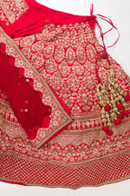 Flat lay of Red Banarasi Silk Womens Lehenga set featuring Embroidered Choli paired with Red Embroidered Skirt with Embroidered Border and a Embroidered dupatta in Red
