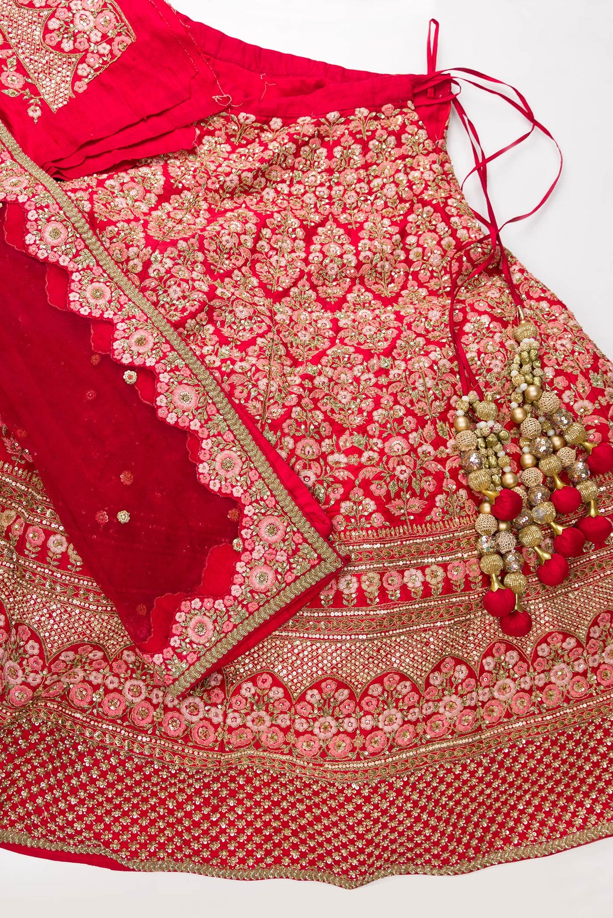 Flat lay of Red Banarasi Silk Womens Lehenga set featuring Embroidered Choli paired with Red Embroidered Skirt with Embroidered Border and a Embroidered dupatta in Red