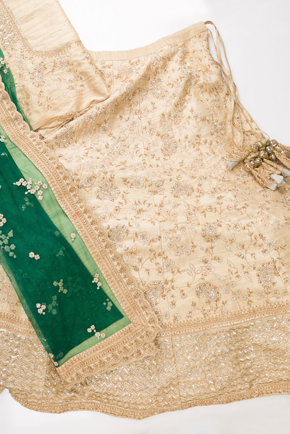 Flat lay of Sandal Banarasi Silk Womens Lehenga set featuring Embroidered Choli paired with Sandal Embroidered Skirt with Embroidered Border and a Embroidered dupatta in Green