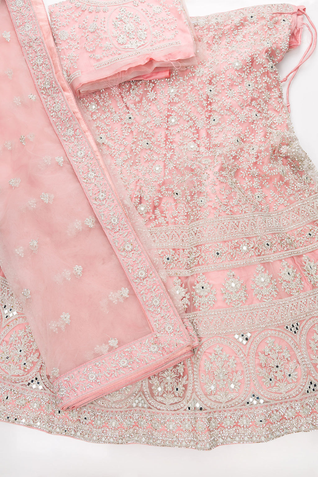 Flat lay of Pink Banarasi Silk Womens Lehenga set featuring Embroidered Choli paired with Pink Embroidered Skirt with Embroidered Border and a Embroidered dupatta in Pink