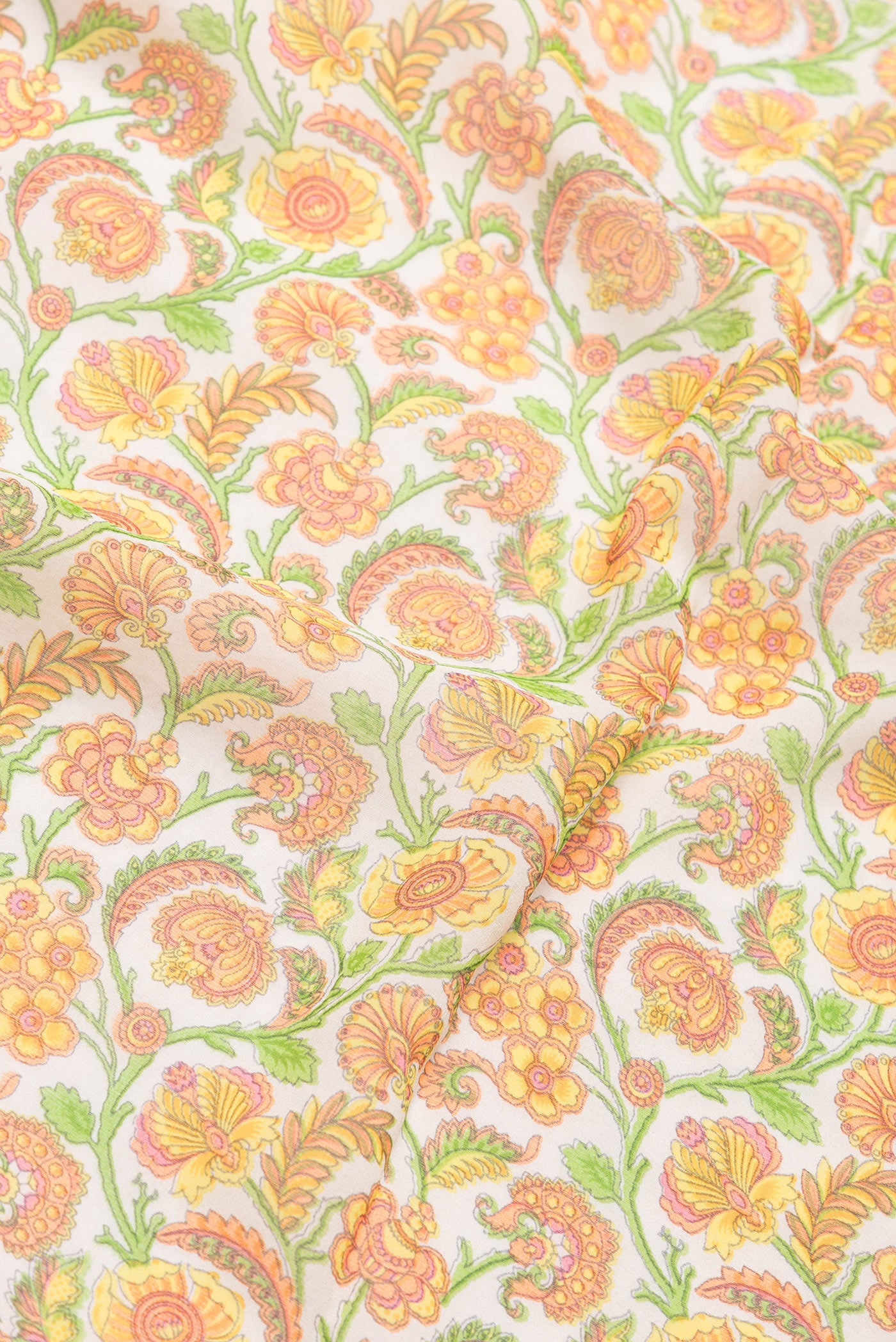 Close up of Beige Dual Tone Mysore Georgette Saree with Printed design on the body and Zari And Thread Border.  displaying folds