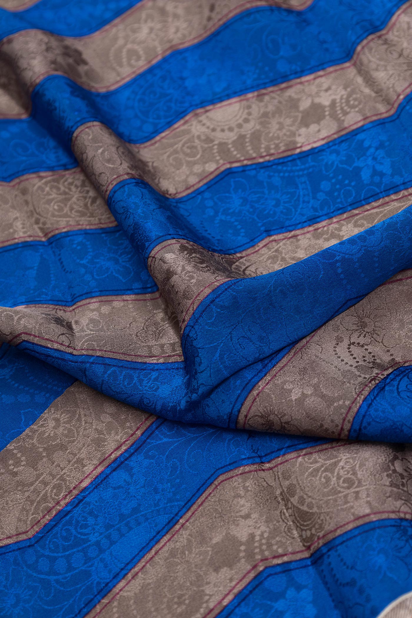 Close up of Pink Dual Tone Mysore Crepe Saree with Printed design on the body and Printed Border.  displaying folds