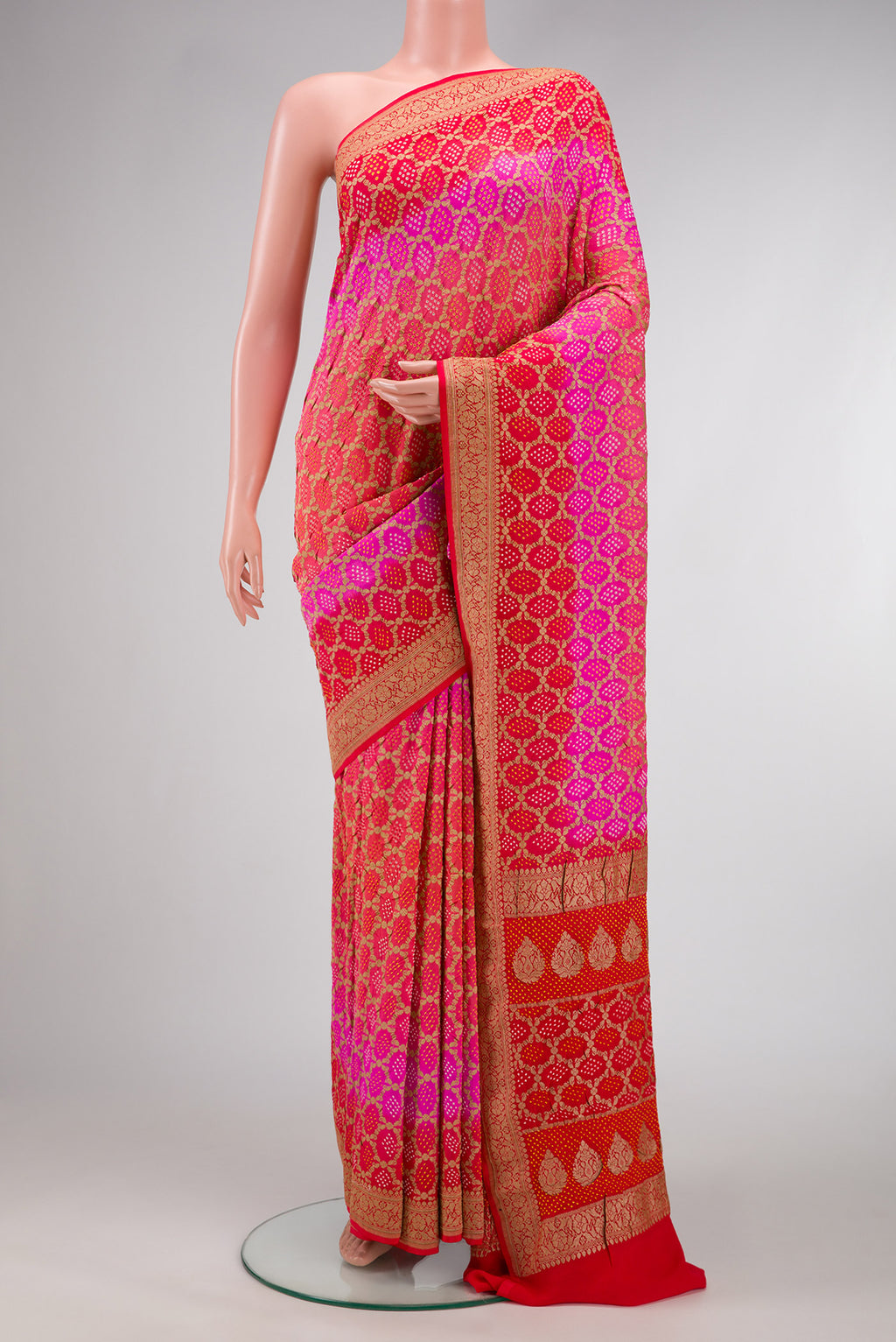 Pink and Red Color Banarasi Georgette Saree with Bandhani Print on the body and Zari Border.  displayed on a mannequin