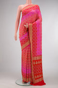 Pink and Red Color Banarasi Georgette Saree with Bandhani Print on the body and Zari Border.  displayed on a mannequin