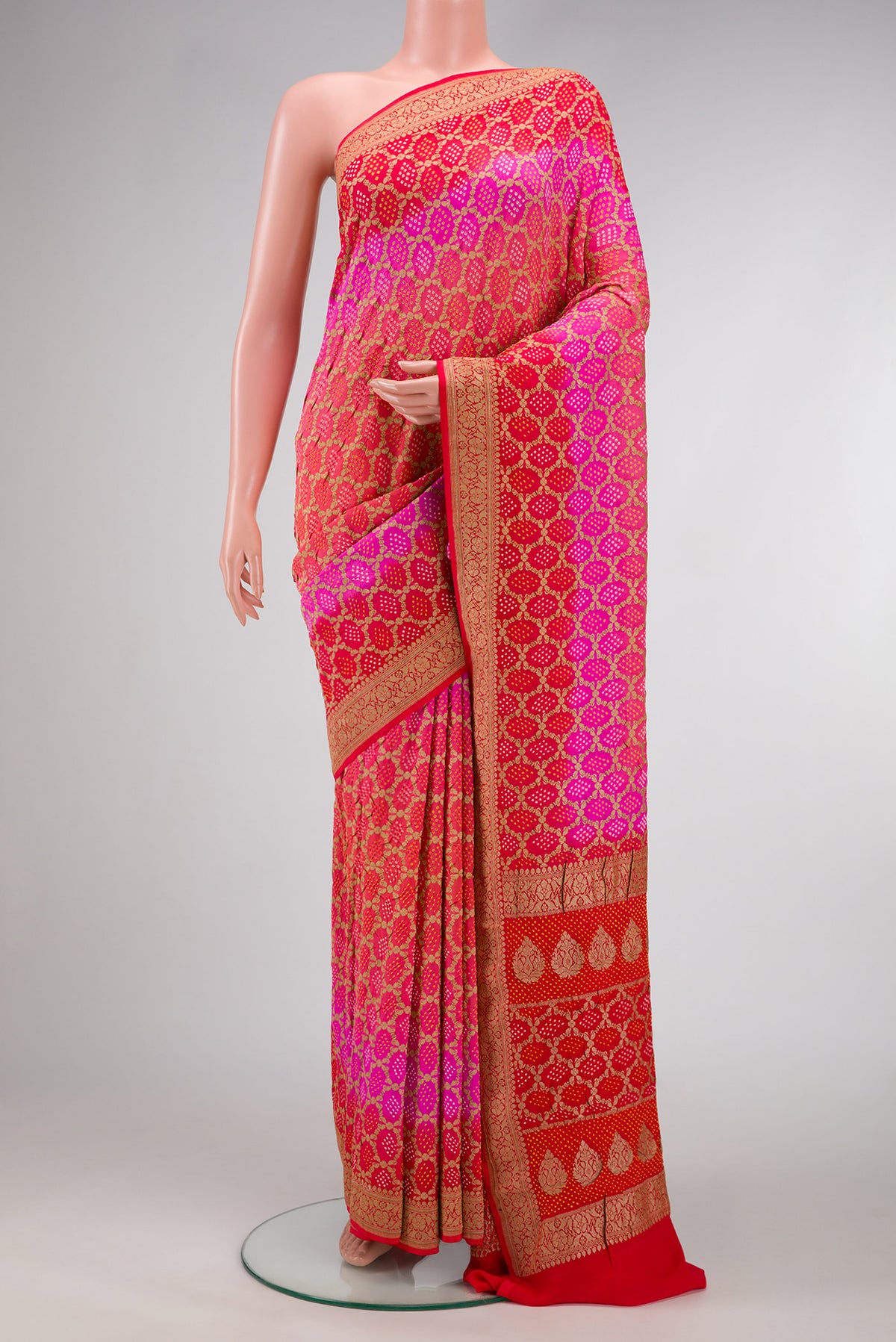 Pink and Red Color Banarasi Georgette Saree with Bandhani Print on the body and Zari Border.  displayed on a mannequin