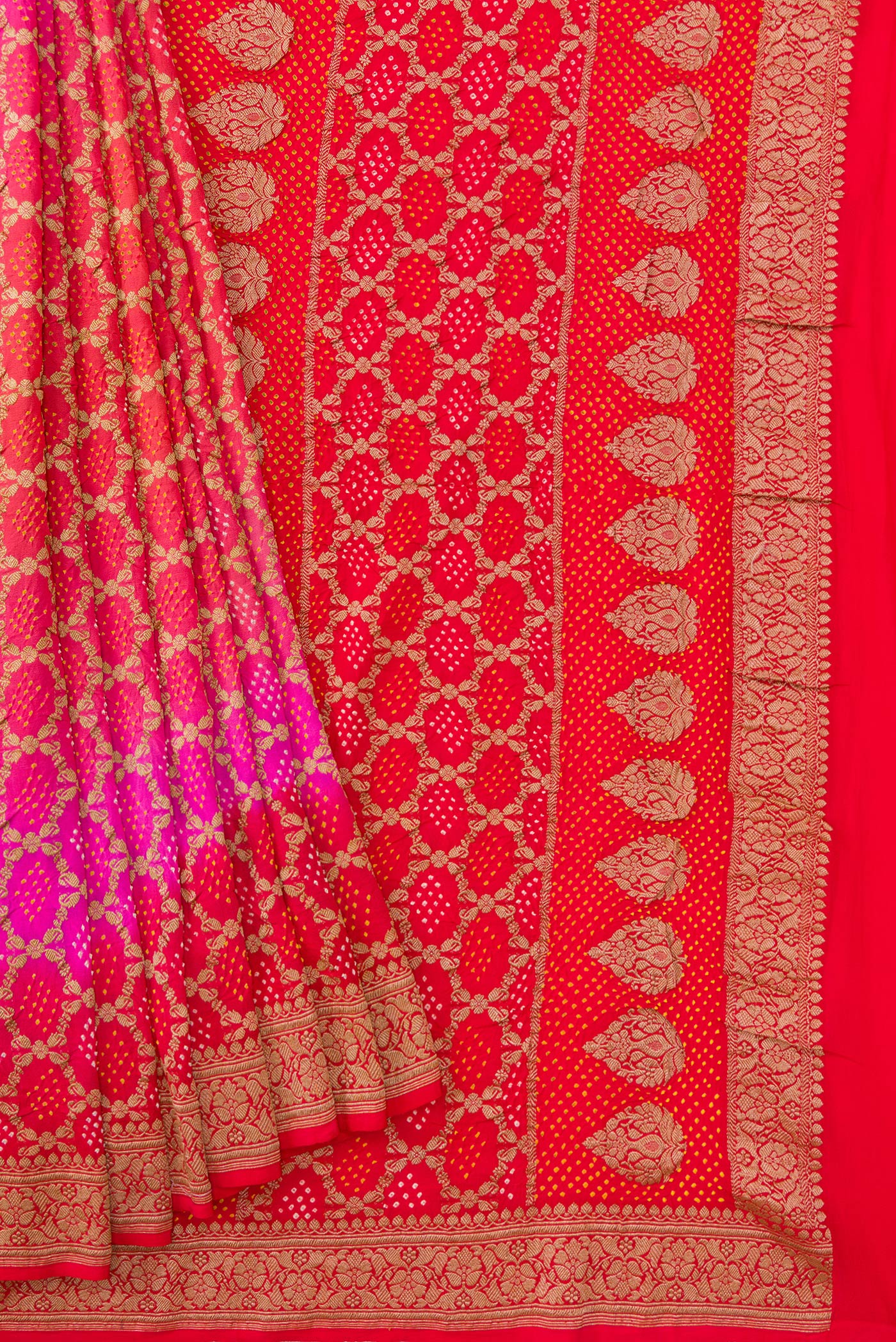 Pleats and pallu of Pink and Red Color Banarasi Georgette Saree with Bandhani Print on the body and Zari Border. 