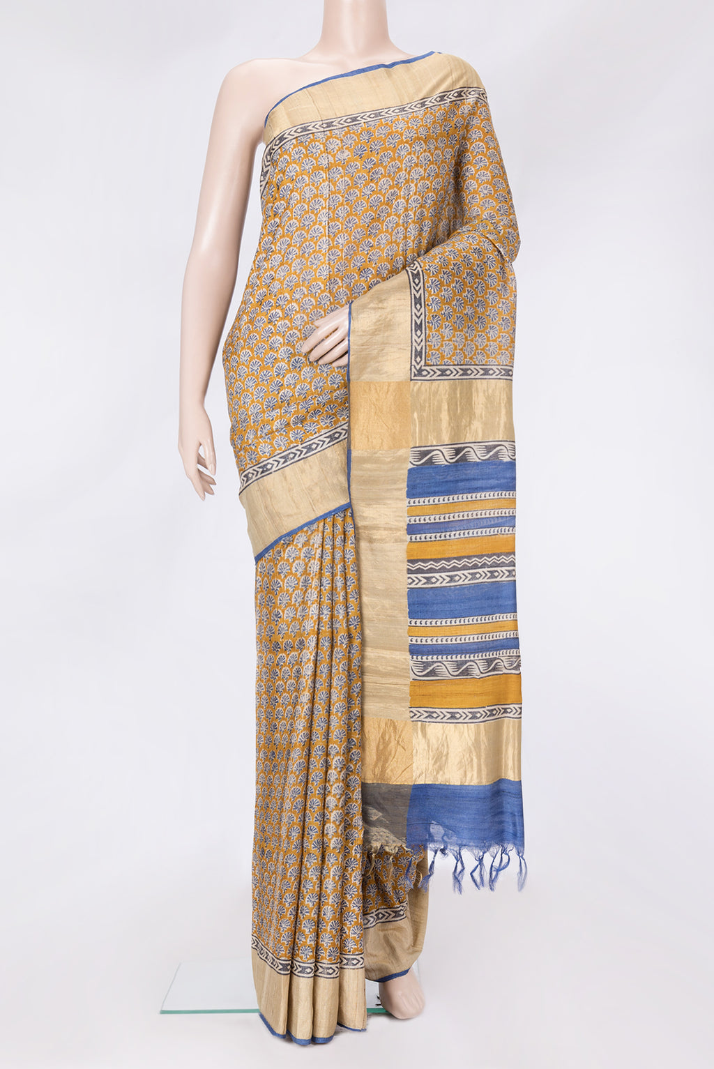 Mustard Dual Tone Tussar Silk Saree with Printed design on the body and Zari Border.  displayed on a mannequin