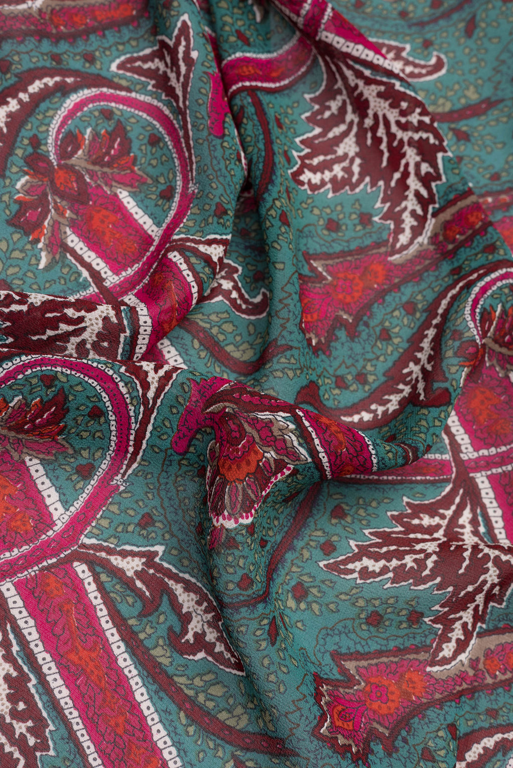 Close up of Green Dual Tone Mysore Georgette Saree with Printed design on the body and Plain Border.  displaying folds