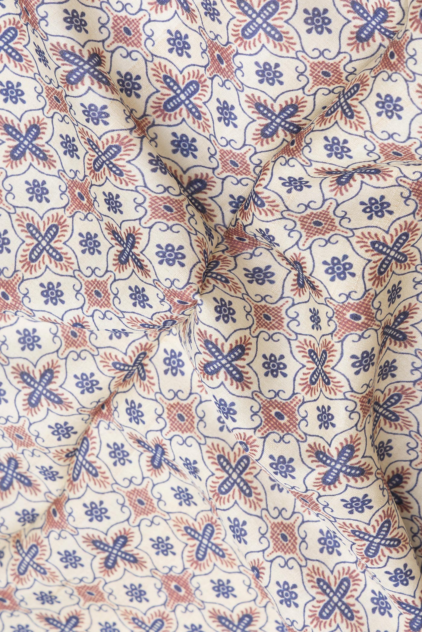 Close up of Beige Tussar Silk Saree with Printed design on the body and Plain Border.  displaying folds