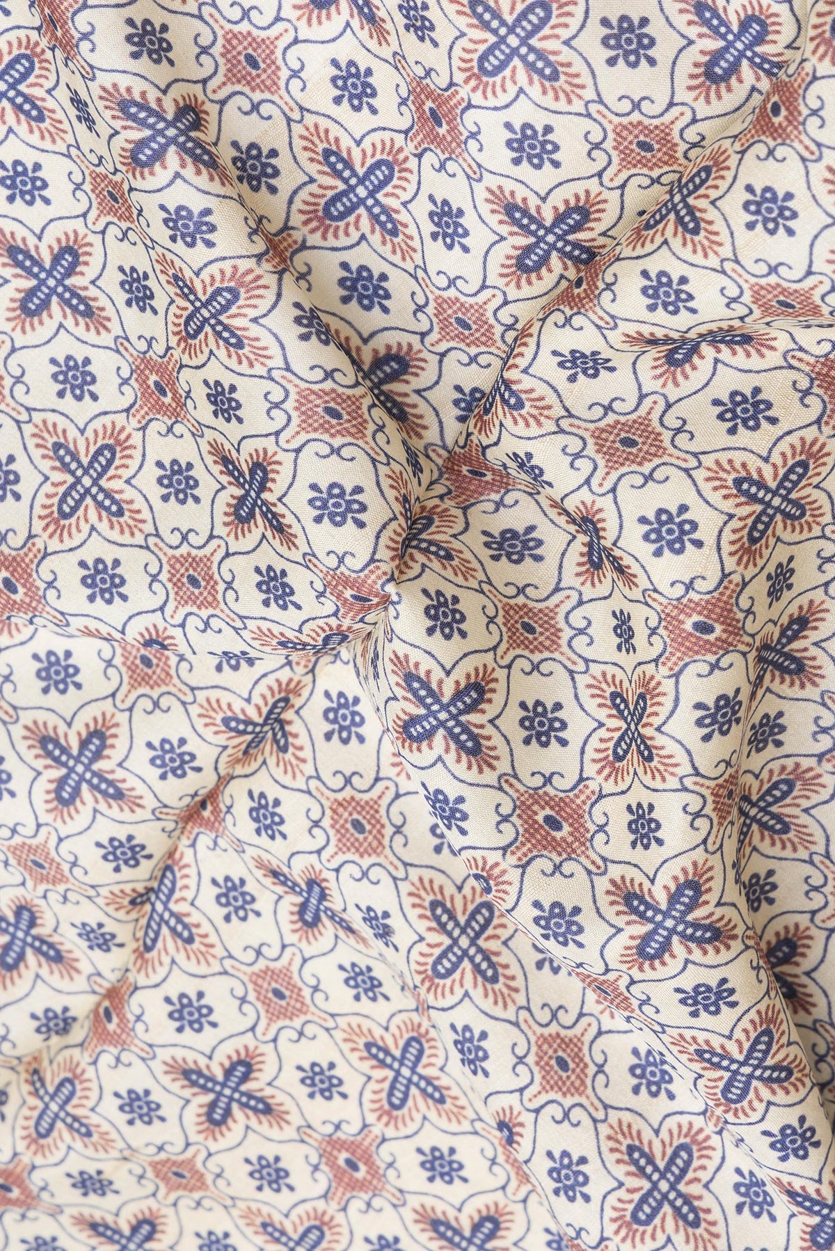Close up of Beige Tussar Silk Saree with Printed design on the body and Plain Border.  displaying folds