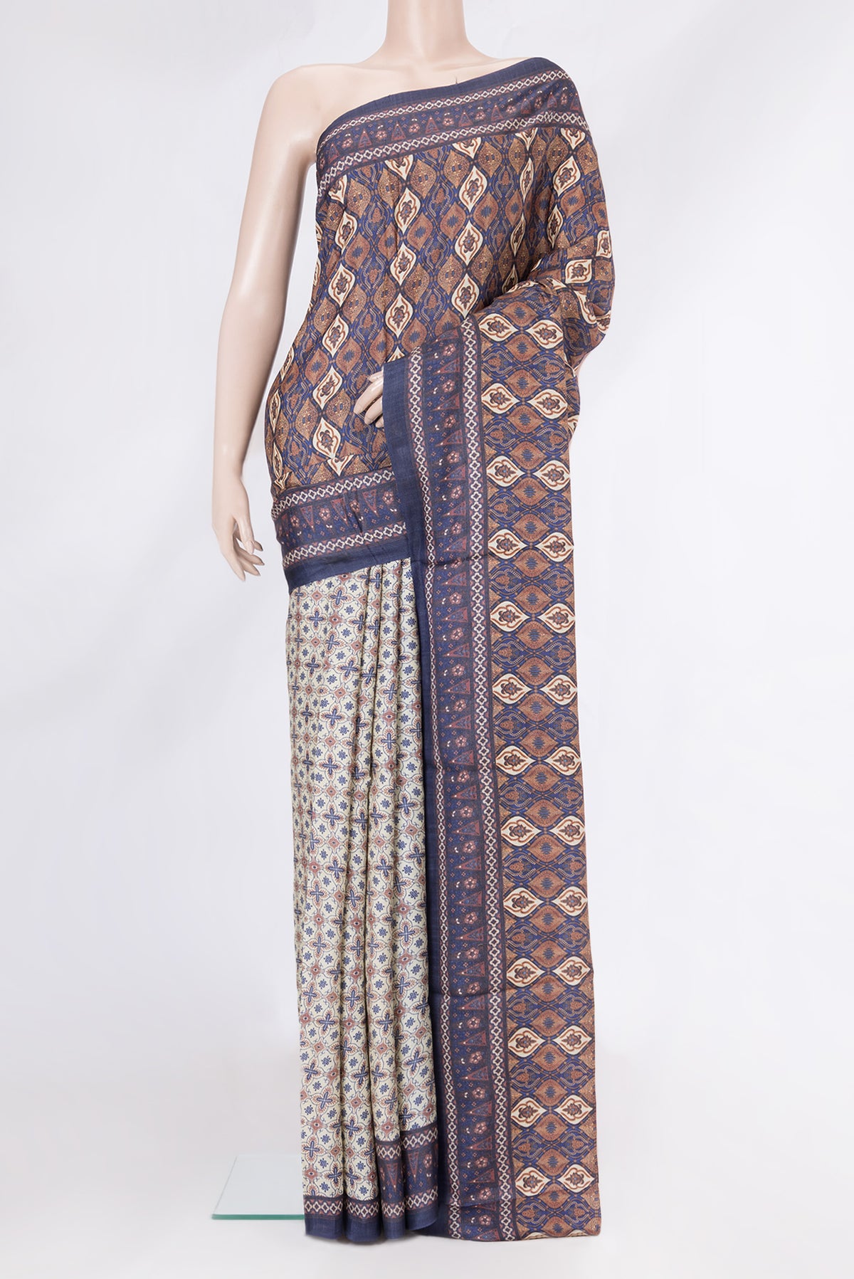 Beige Tussar Silk Saree with Printed design on the body and Plain Border.  displayed on a mannequin