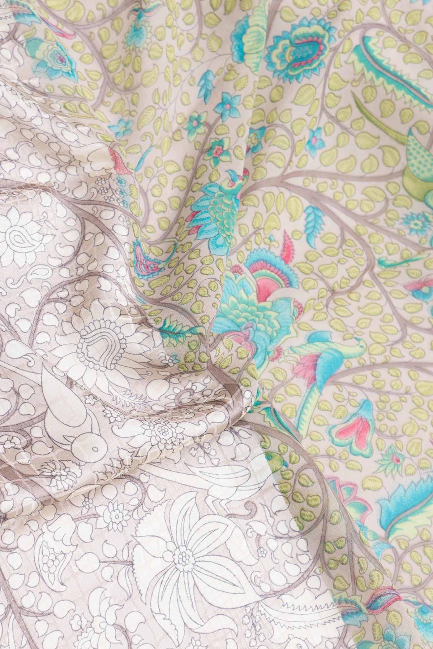 Close up of Grey Dual Tone Mysore Crepe Saree with Printed design on the body and Without Border.  displaying folds