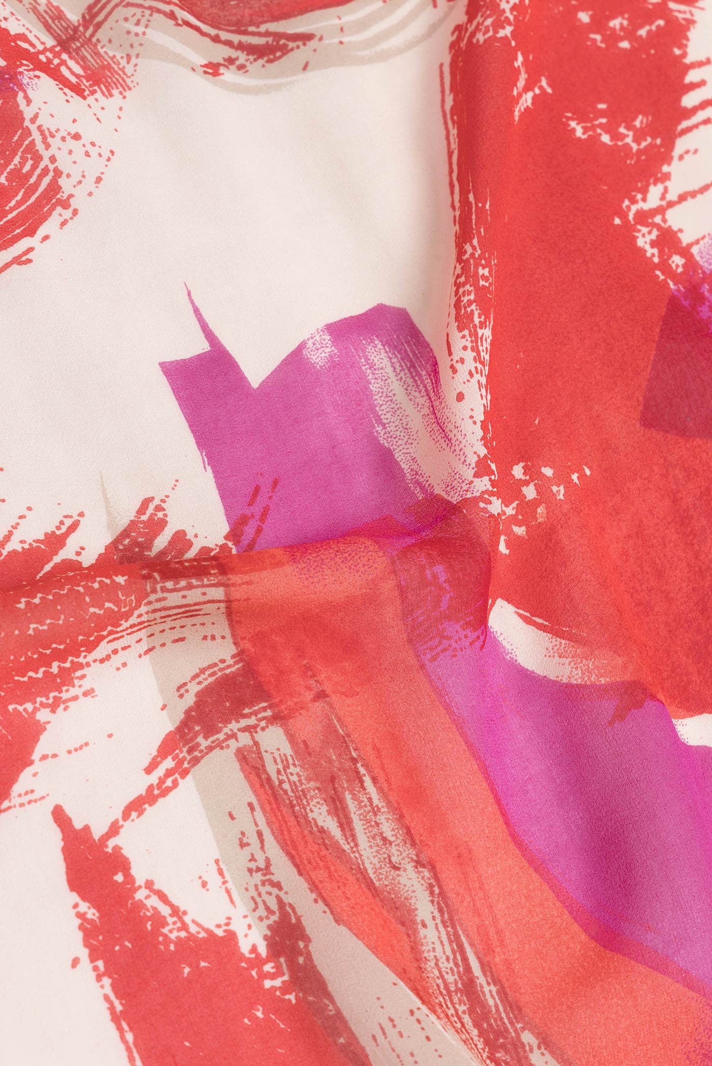 Close up of Red Dual Tone Mysore Georgette Saree with Printed design on the body and Zari Border.  displaying folds