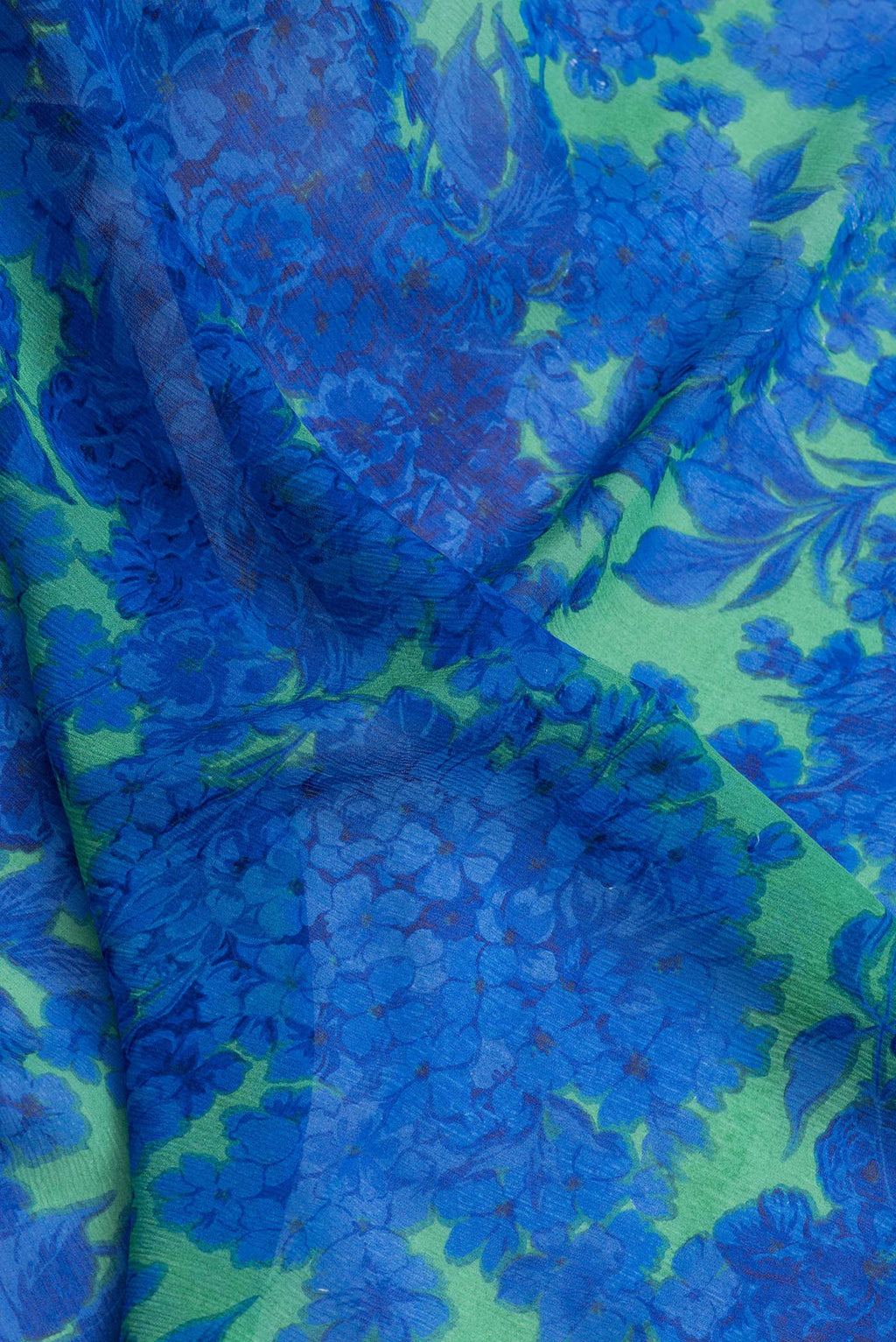 Close up of Parrot Green Dual Tone Mysore Chiffon Saree with Printed design on the body and Zari Border.  displaying folds