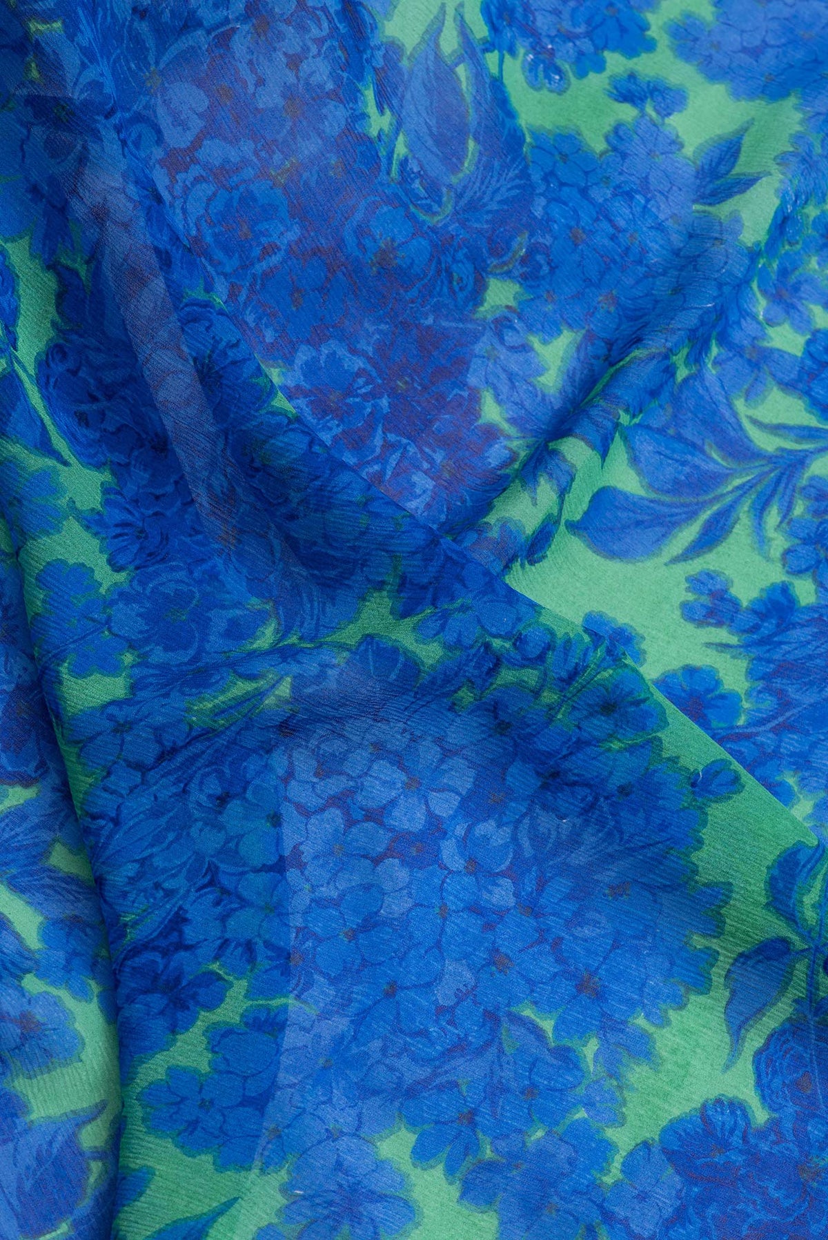 Close up of Parrot Green Dual Tone Mysore Chiffon Saree with Printed design on the body and Zari Border.  displaying folds