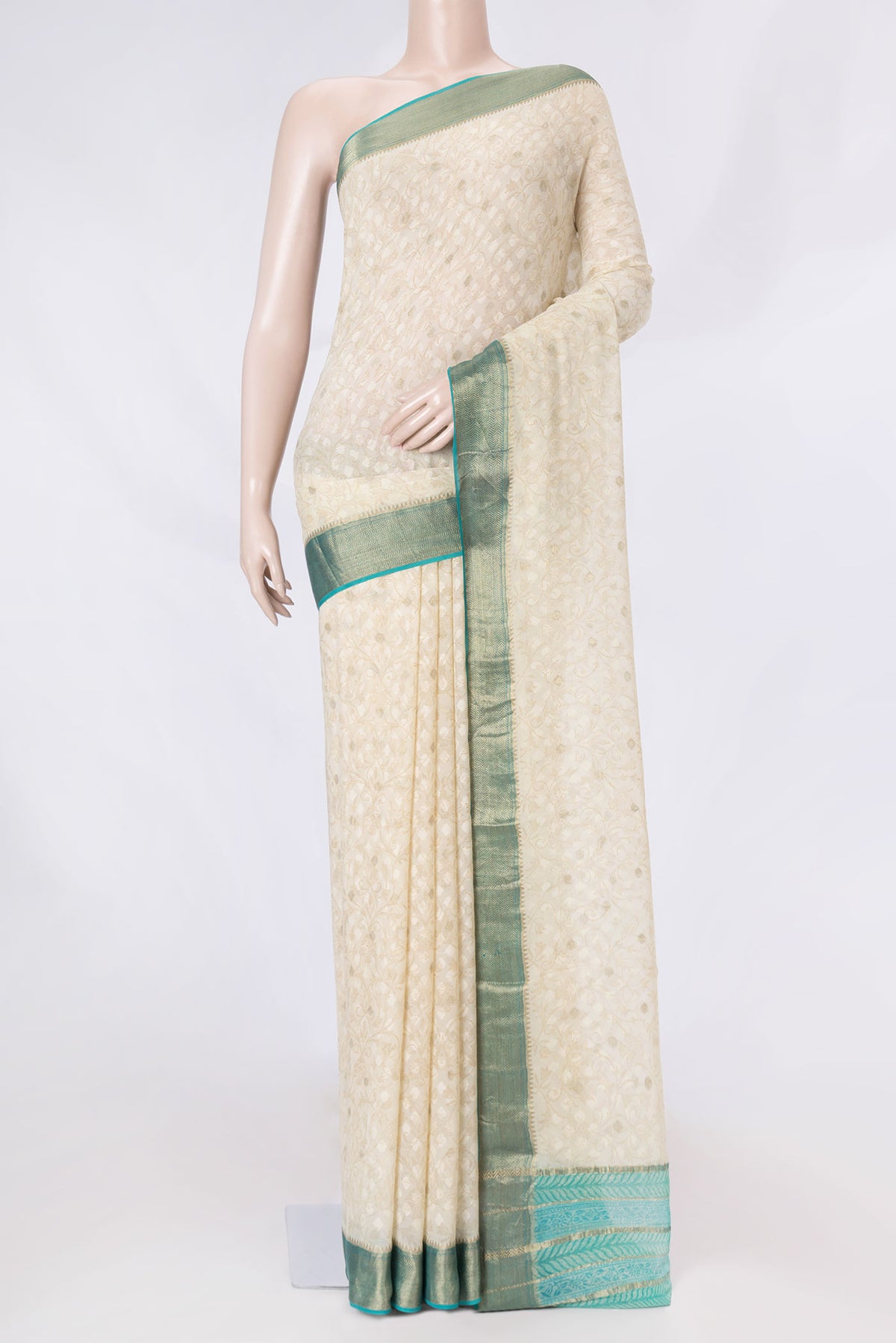 Cream Mysore Georgette Saree with Thread Butta on the body and Zari Border displayed on a mannequin