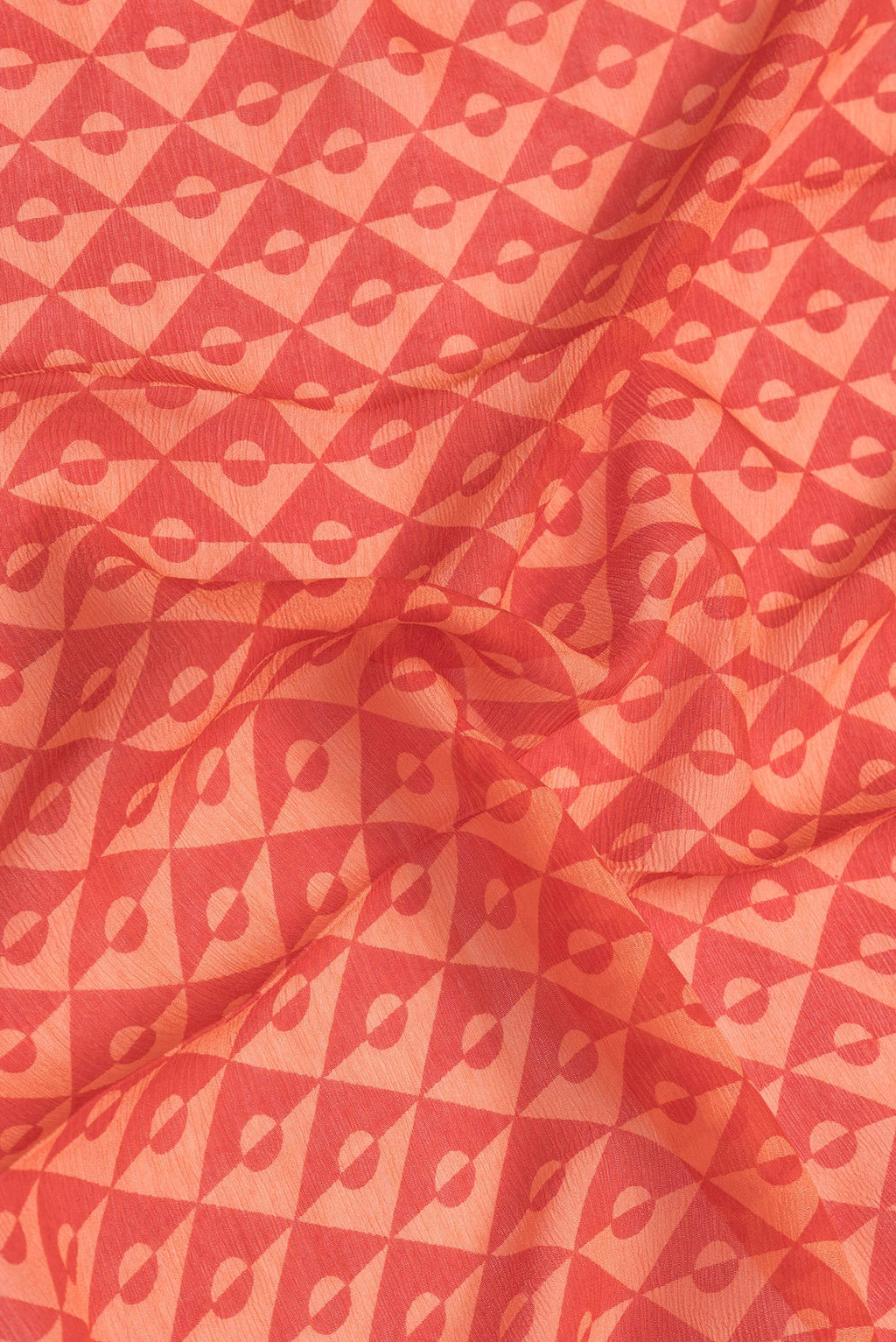 Close up of Red Dual Tone Mysore Chiffon Saree with Printed design on the body and Checks Border.  displaying folds