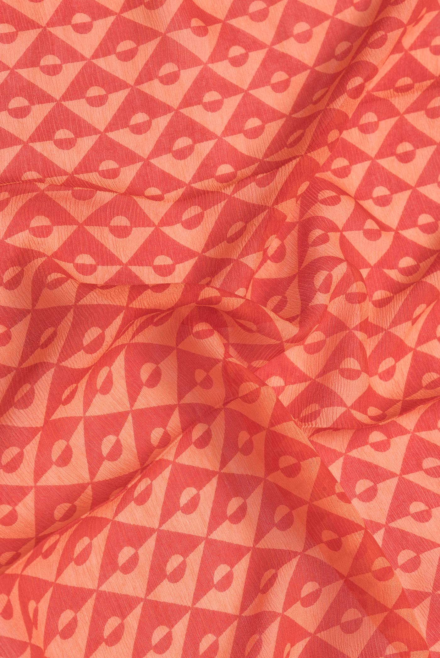 Close up of Red Dual Tone Mysore Chiffon Saree with Printed design on the body and Checks Border.  displaying folds