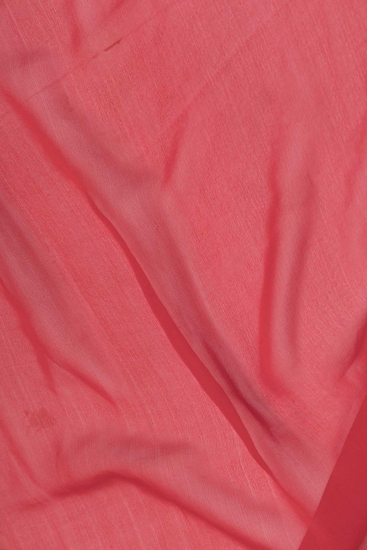 Close up of Red Dual Tone Banarasi Georgette Saree with Plain Body and Zari Border displaying folds