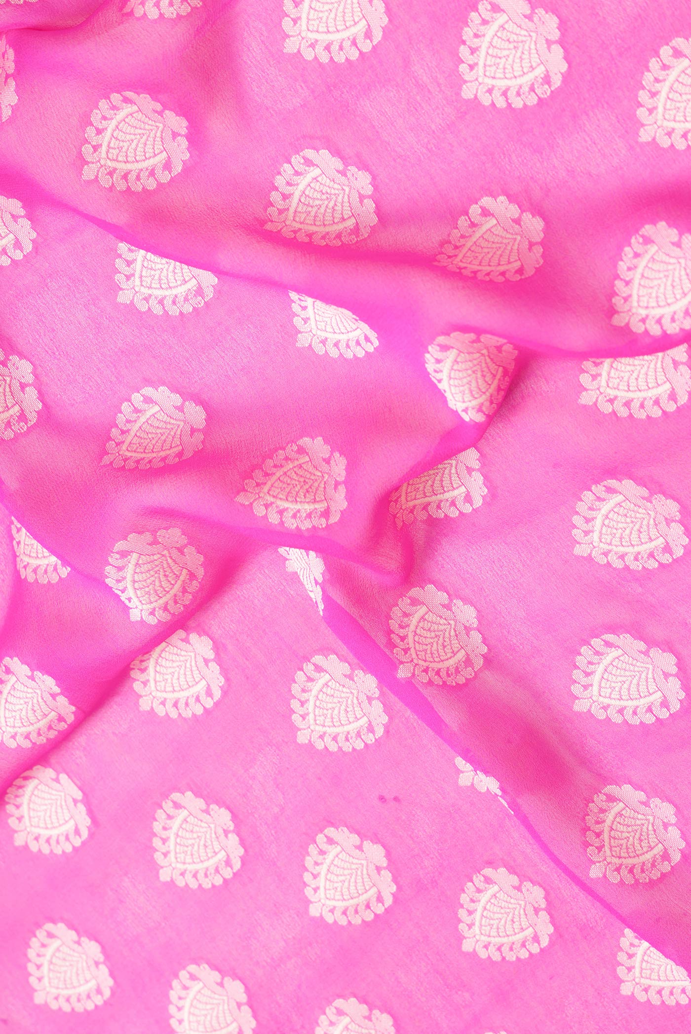 Close up of Pink Dual Tone Mysore Georgette Saree with Zari Butta on the body and Thread Border.  displaying folds