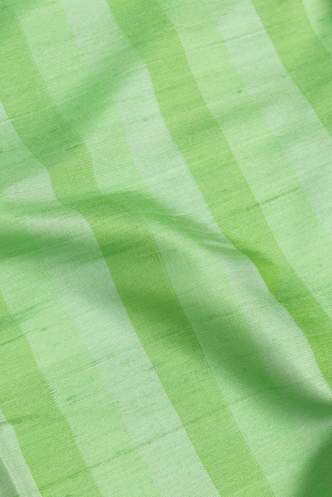 Close up of Green Dual Tone Tussar Silk Saree with Stripes on the body and Zari Border.  displaying folds