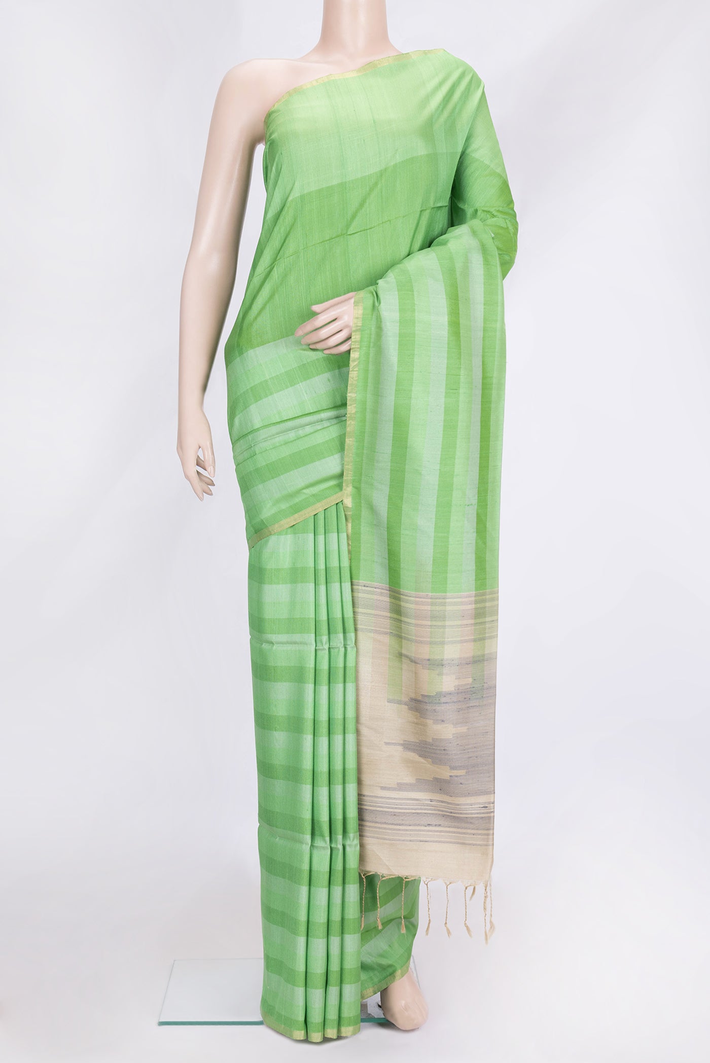 Green Dual Tone Tussar Silk Saree with Stripes on the body and Zari Border.  displayed on a mannequin
