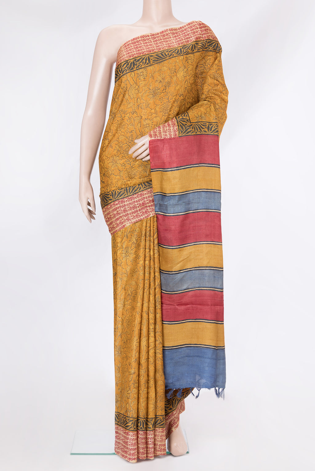 Mustard Tussar Silk Saree with Printed design on the body and Fancy Border.  displayed on a mannequin
