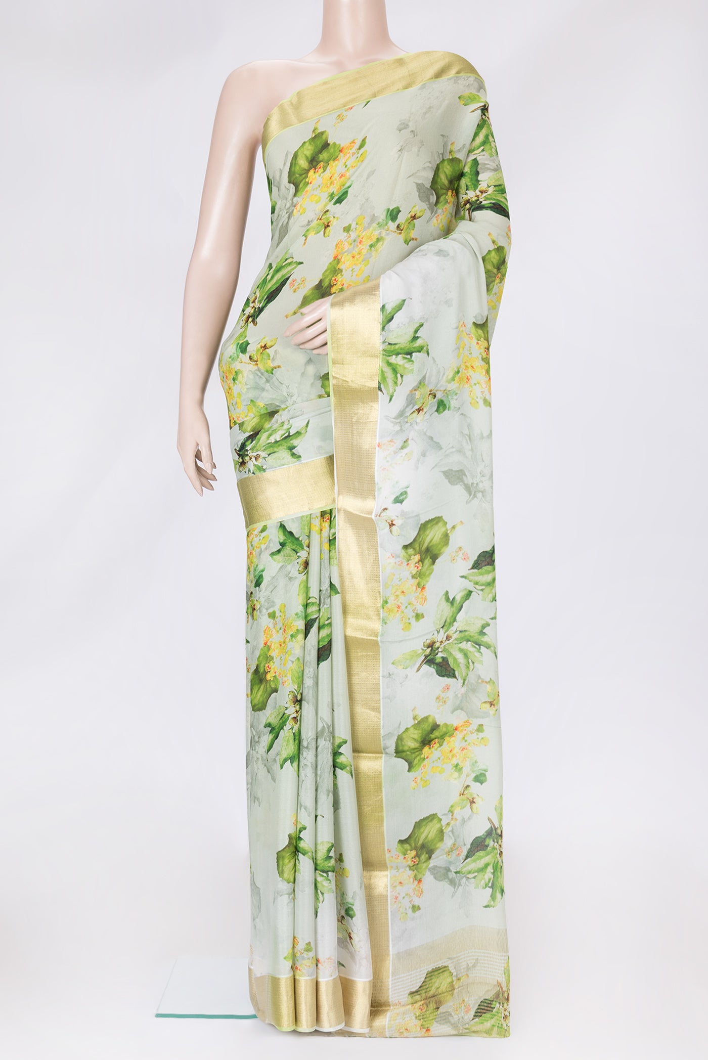 Pista Green Dual Tone Mysore Crepe Saree with Printed design on the body and Zari Border.  displayed on a mannequin