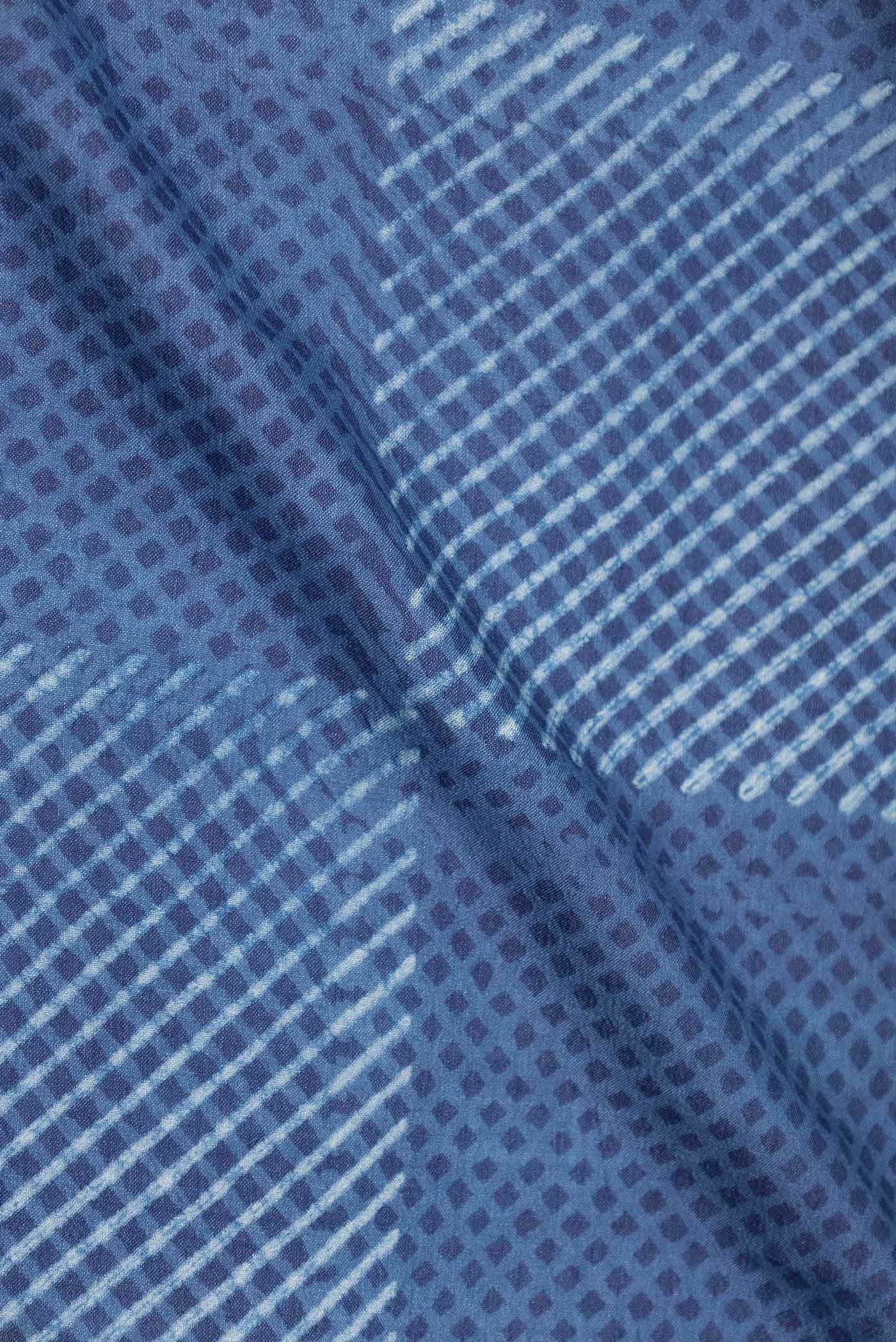 Close up of Blue Dual Tone Tussar Silk Saree with Printed design on the body and Printed Border displaying folds