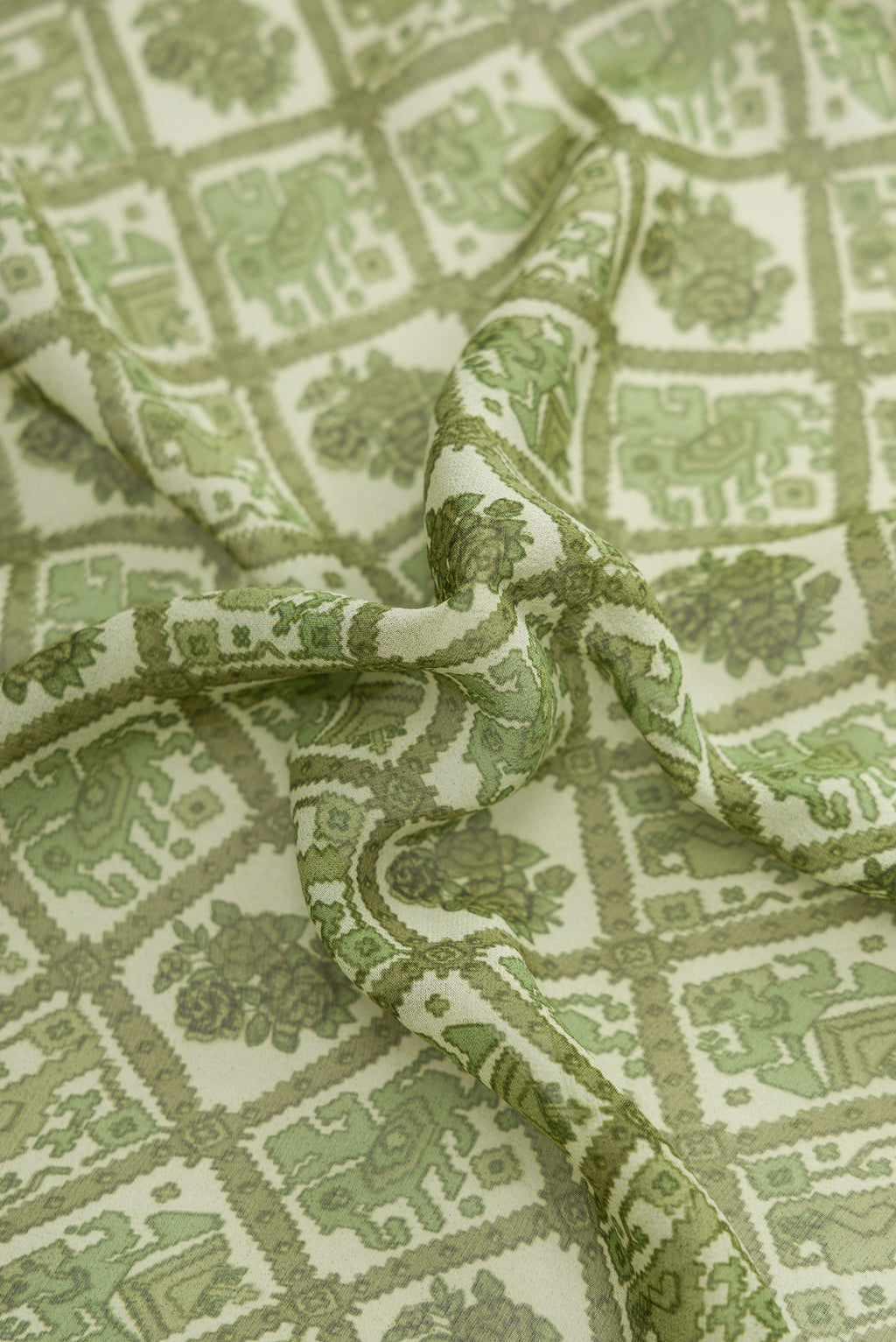 Close up of Green Dual Tone Mysore Crepe Saree with Printed design on the body and Printed Border.  displaying folds