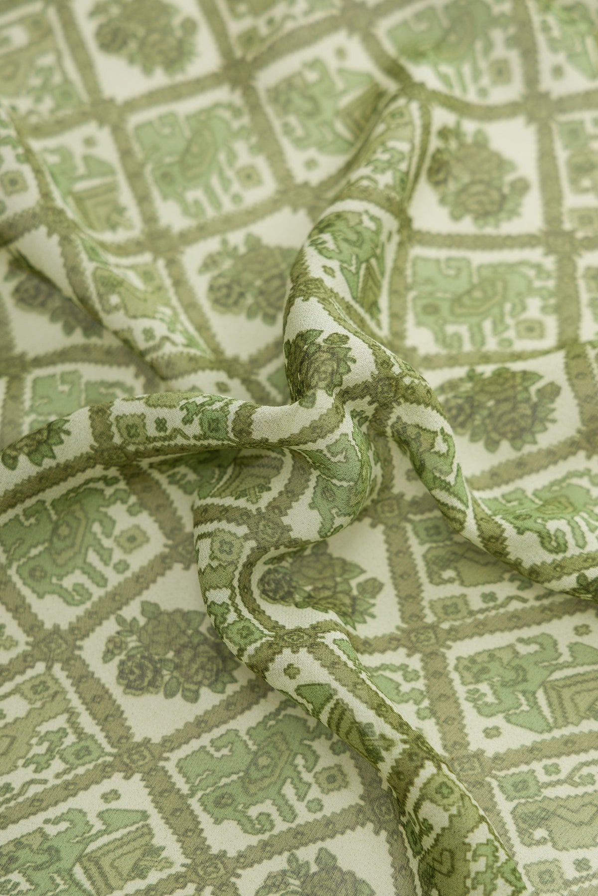 Close up of Green Dual Tone Mysore Crepe Saree with Printed design on the body and Printed Border.  displaying folds