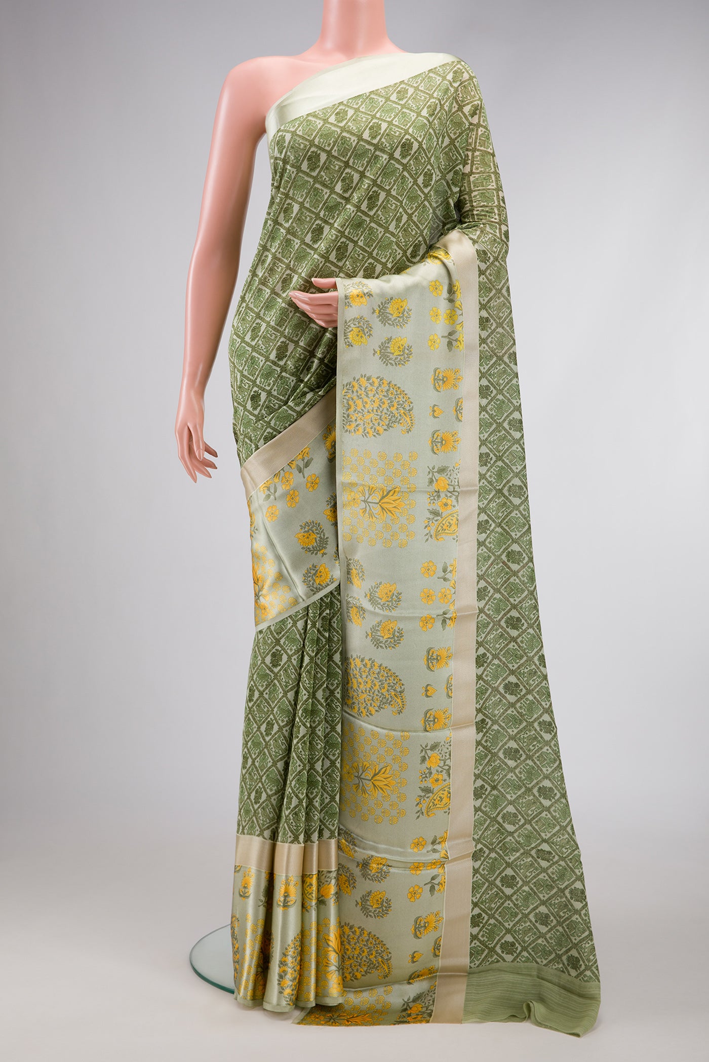 Green Dual Tone Mysore Crepe Saree with Printed design on the body and Printed Border.  displayed on a mannequin