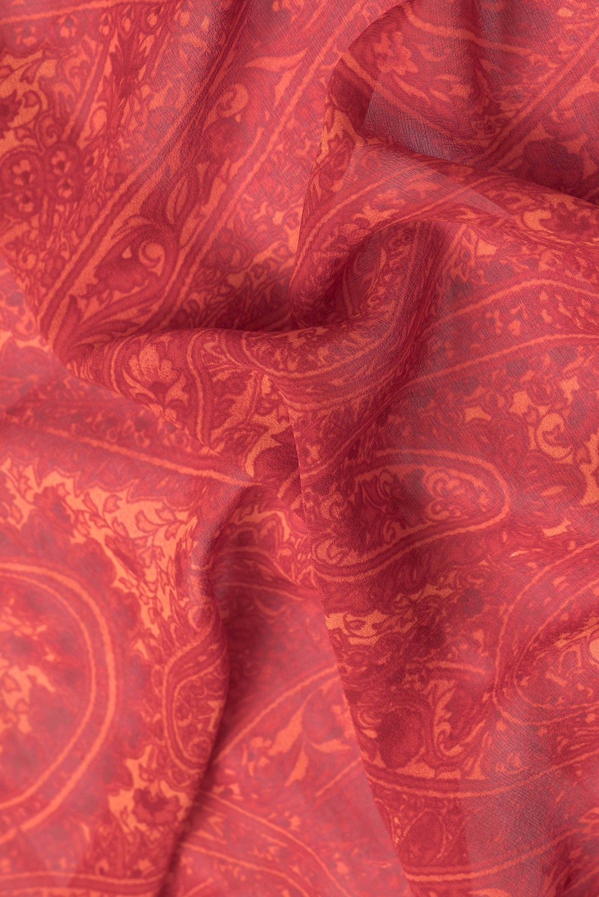 Close up of Red Dual Tone Mysore Crepe Saree with Printed design on the body and Printed Border.  displaying folds