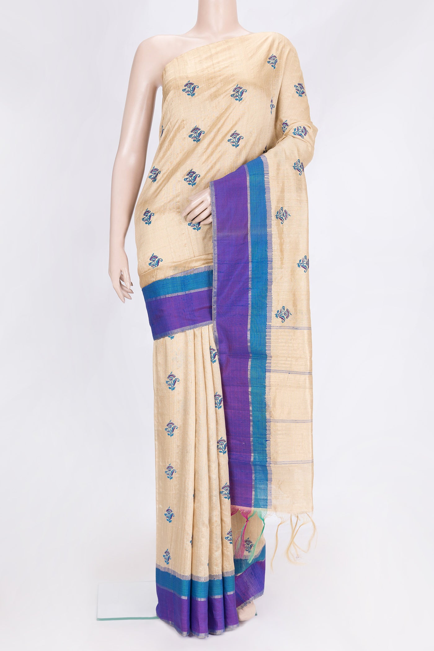 Beige Dual Tone Tussar Silk Saree with Embroidery on the body and Zari Border.  displayed on a mannequin