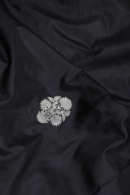 Close up of Black Dual Tone Banarasi Saree with Zari Butta on the body and Without Border displaying folds