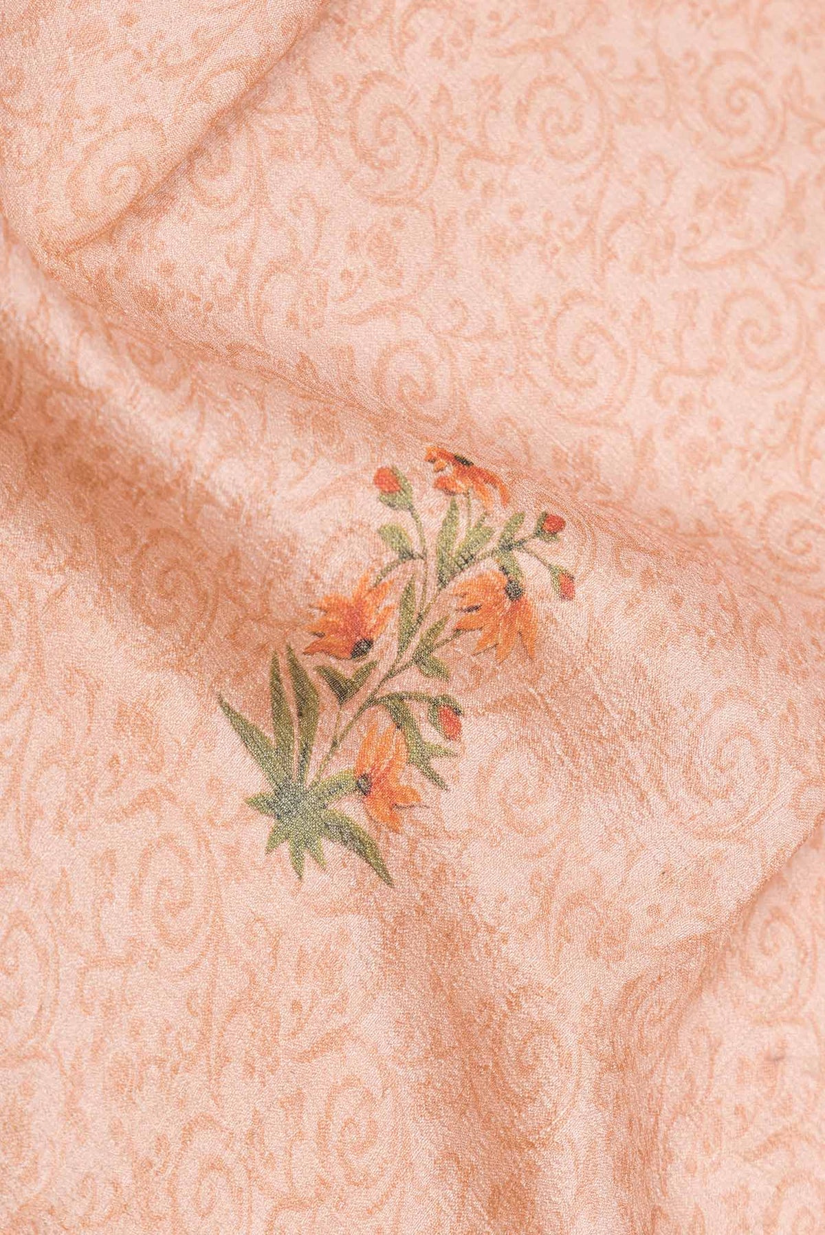 Close up of Peach Dual Tone Blended Tussar Silk Saree with Printed design on the body and Fancy Border displaying folds