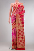 Pink and Red Color Bandhani Silk Saree with Bandhani Print on the body and Zari Border.  displayed on a mannequin