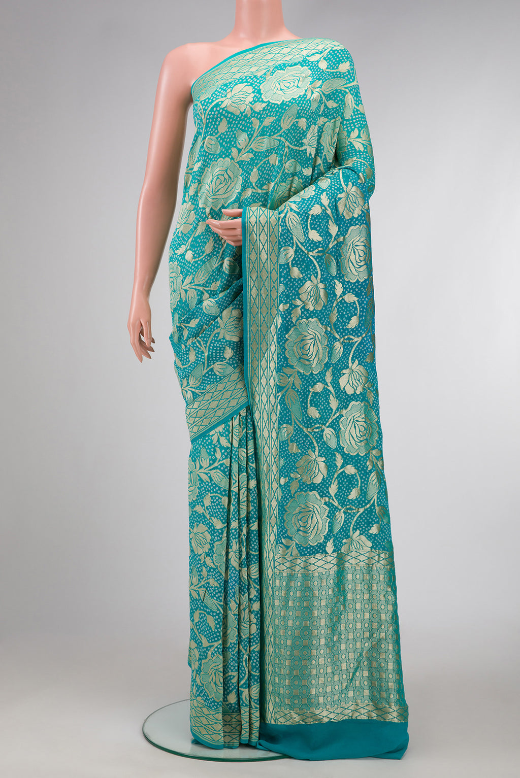 Sky Blue Dual Tone Bandhani Silk Saree with Bandhani Print on the body and Zari Border.  displayed on a mannequin