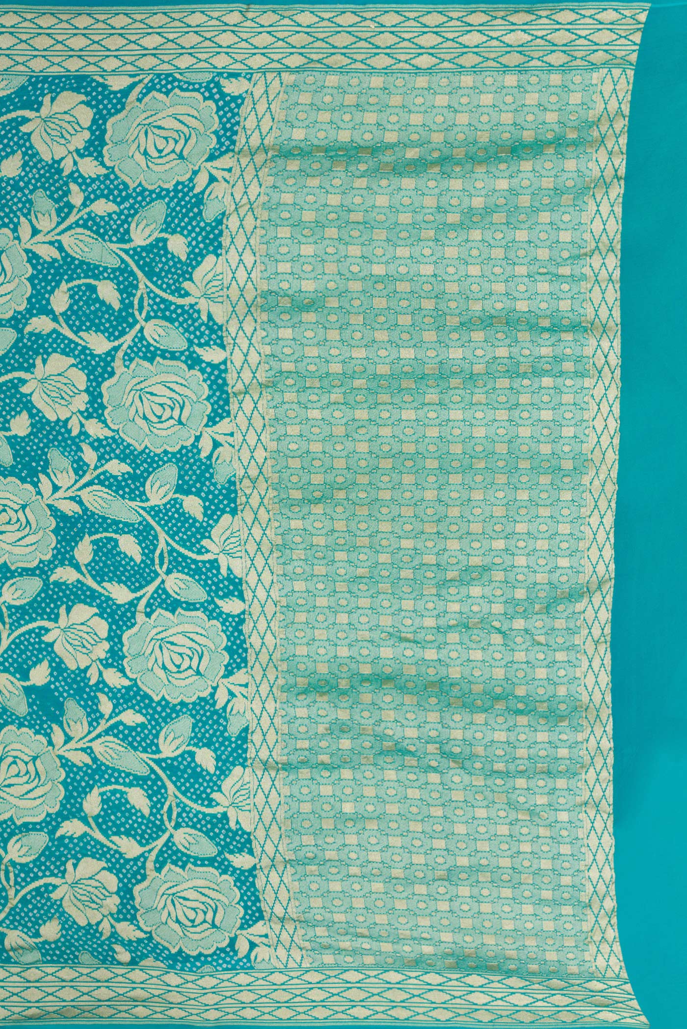 Close up image of the pallu of Sky Blue Dual Tone Bandhani Silk Saree with Bandhani Print on the body and Zari Border. 