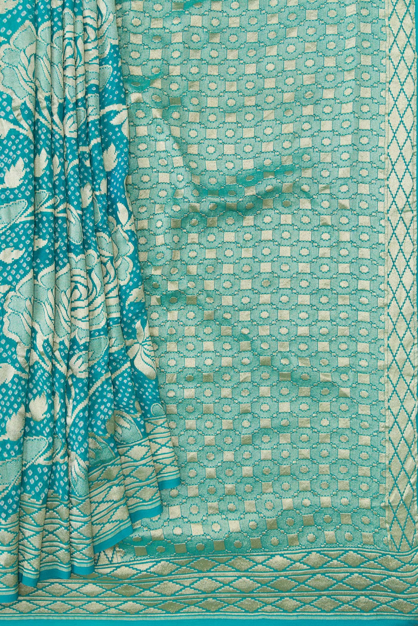 Pleats and pallu of Sky Blue Dual Tone Bandhani Silk Saree with Bandhani Print on the body and Zari Border. 