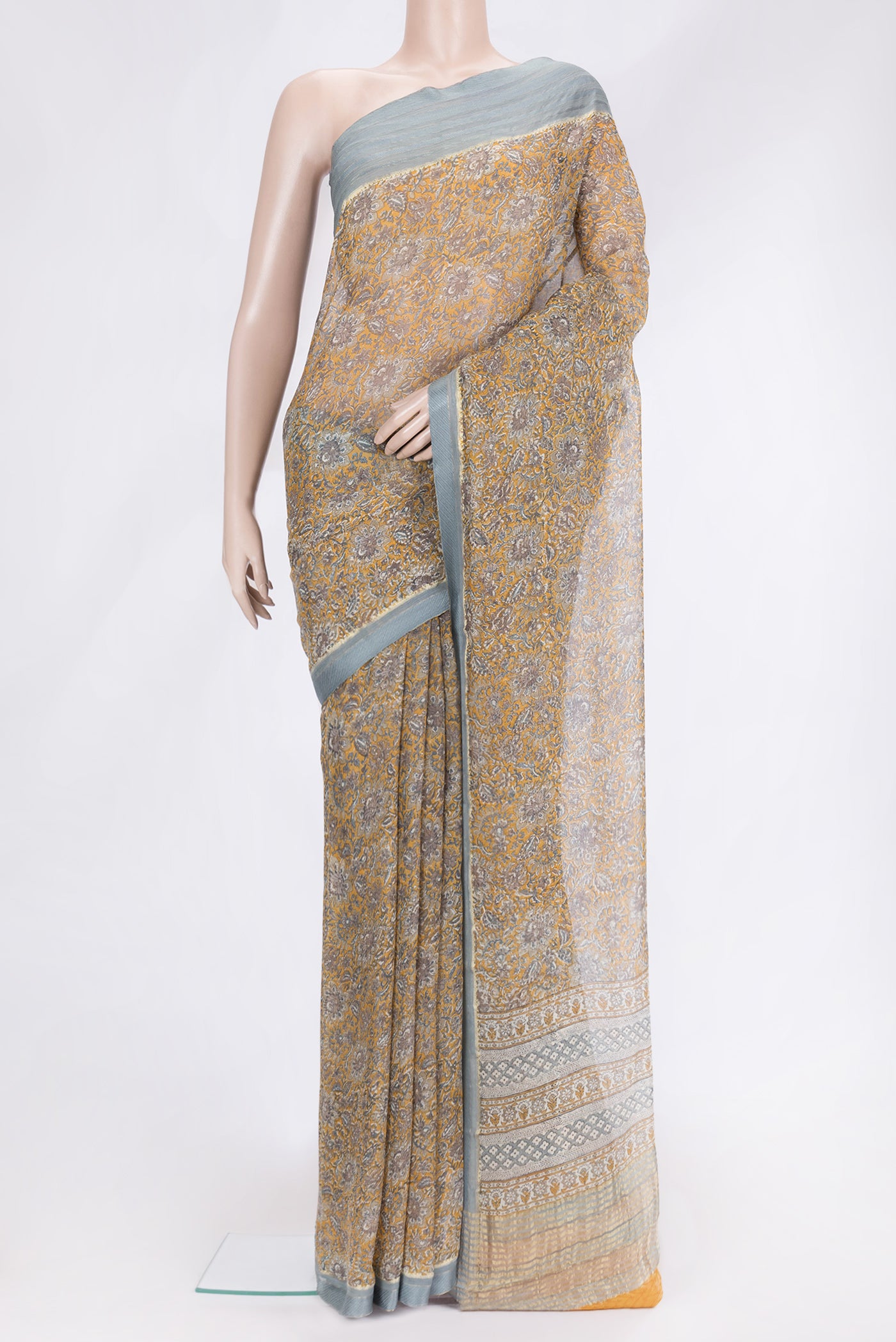 Mustard Dual Tone Mysore Chiffon Saree with Printed design on the body and Zari And Thread Border.  displayed on a mannequin