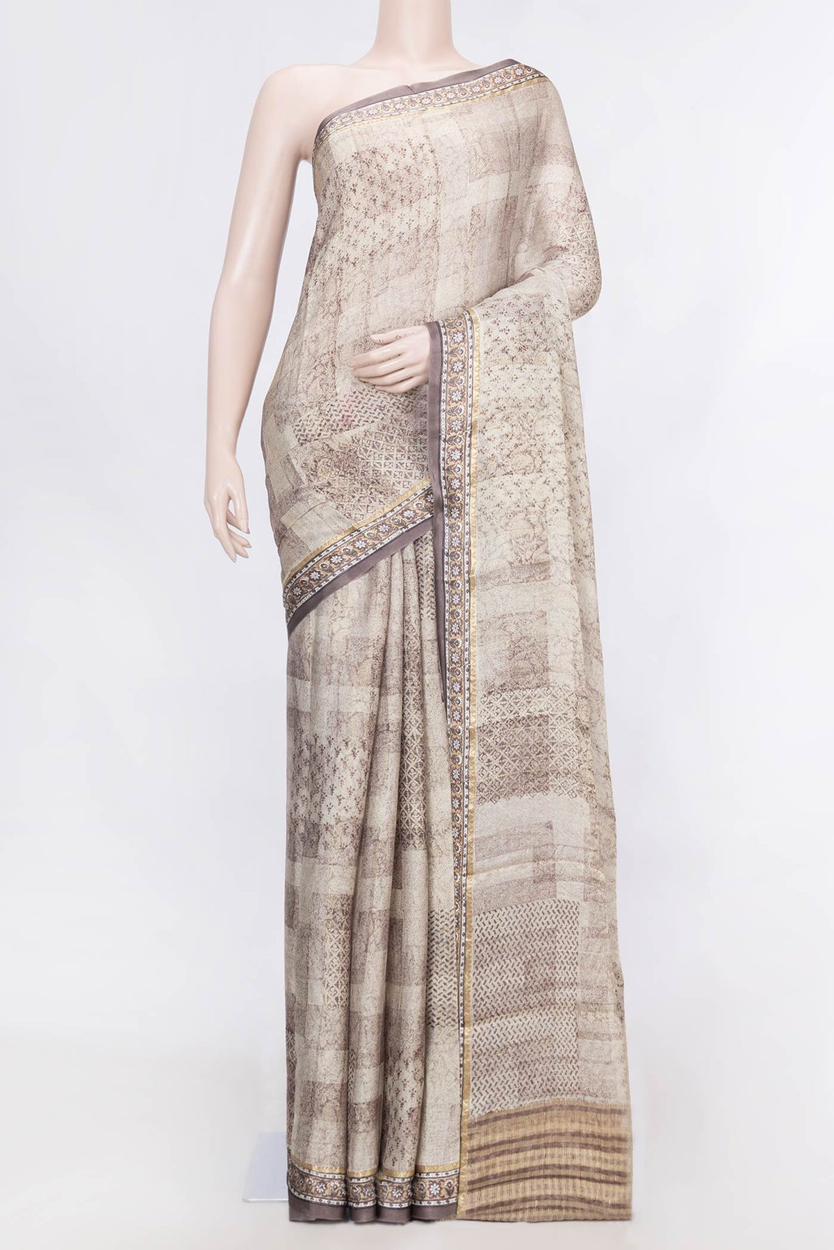 Beige Dual Tone Mysore Georgette Saree With Printed design on the body and Zari Border displayed on a mannequin