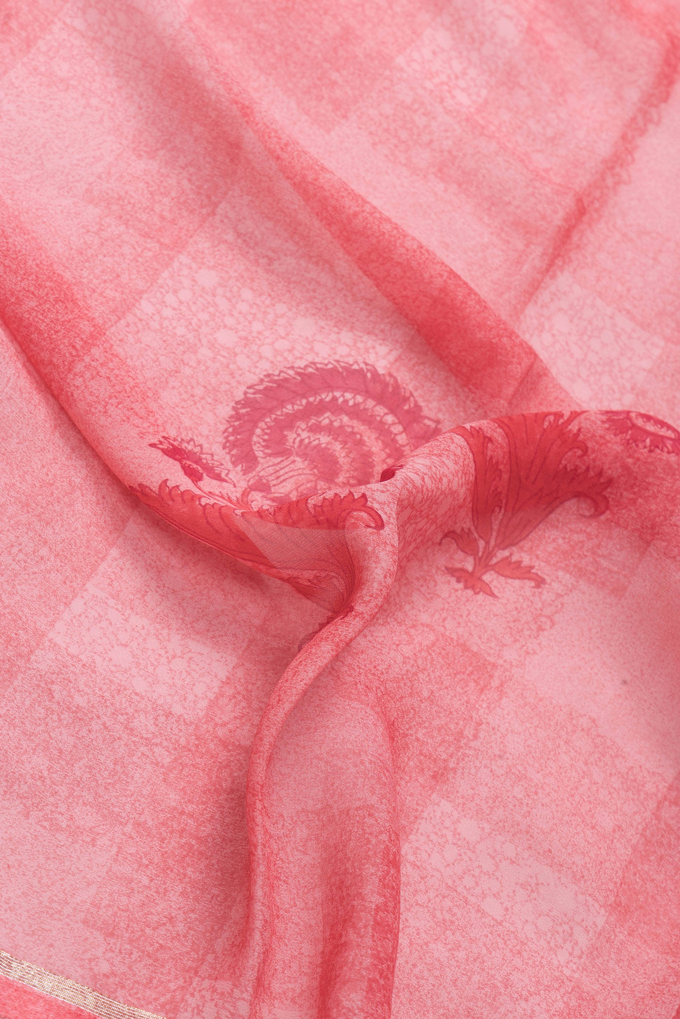 Close up of Pink Dual Tone Georgette Saree with Printed design on the body and Zari Border.  displaying folds