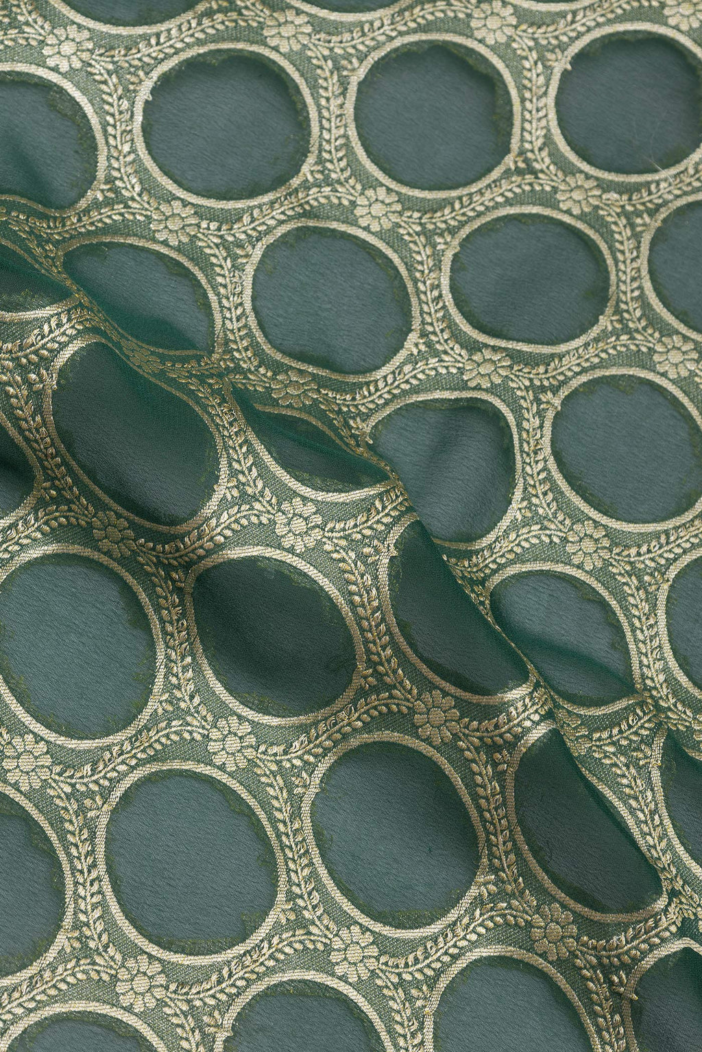 Close up of Bottle Green Banarasi Georgette Saree with Zari Brocade on the body and Zari Border.  displaying folds