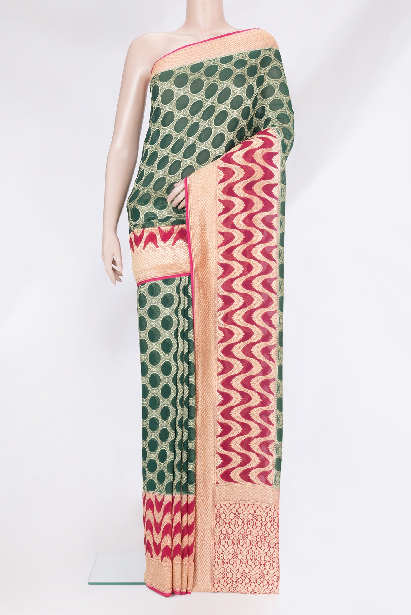 Bottle Green Banarasi Georgette Saree with Zari Brocade on the body and Zari Border.  displayed on a mannequin