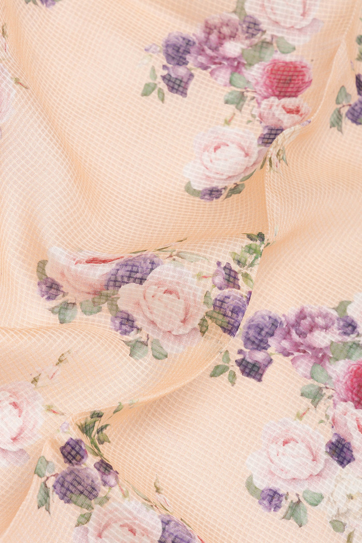 Close up of Peach Dual Tone Kota Silk Saree with Checked design on the body and Plain Border.  displaying folds