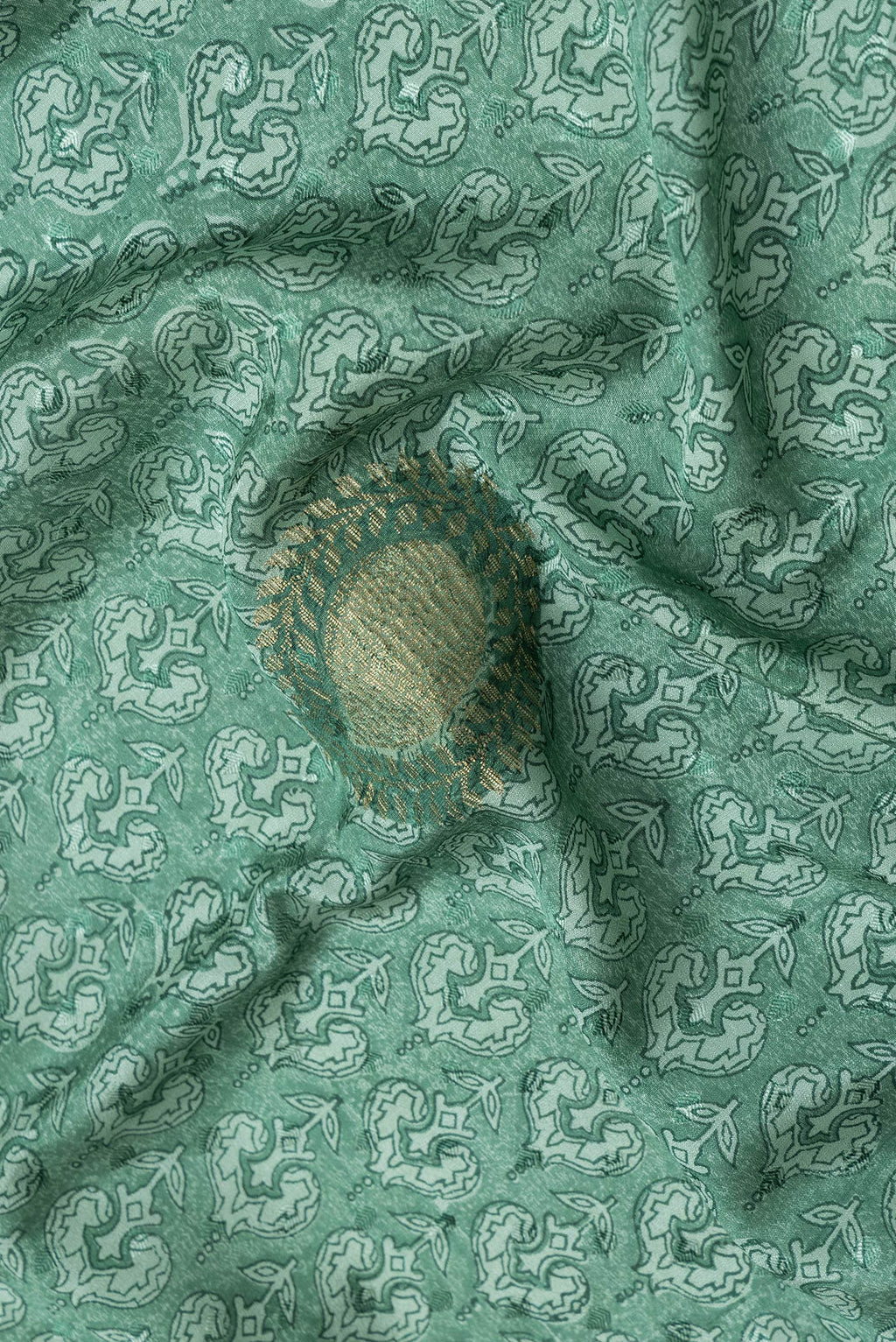 Close up of Green Dual Tone Mysore Crepe Saree with Printed design on the body and Zari Border.  displaying folds