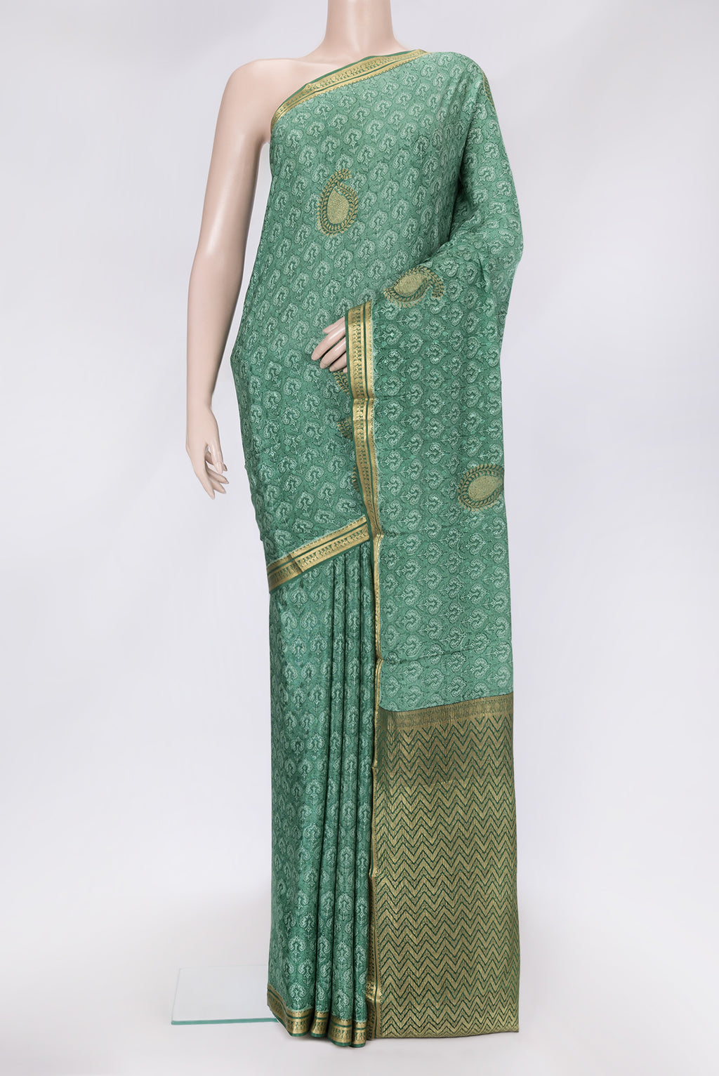 Green Dual Tone Mysore Crepe Saree with Printed design on the body and Zari Border.  displayed on a mannequin