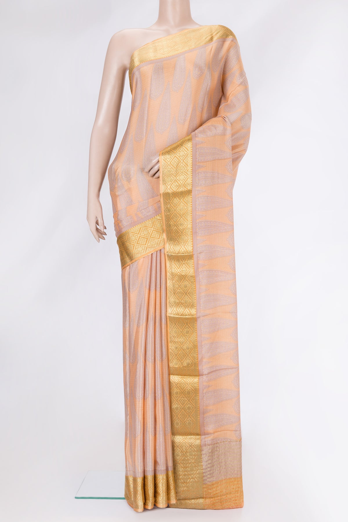 Peach Dual Tone Mysore Crepe Saree with Printed design on the body and Zari Border.  displayed on a mannequin
